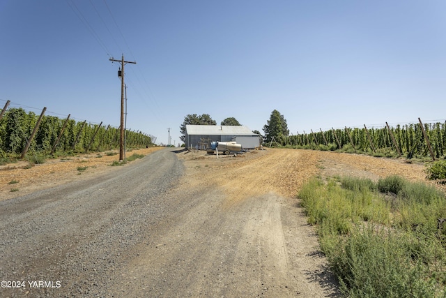 view of street featuring driveway and a rural view