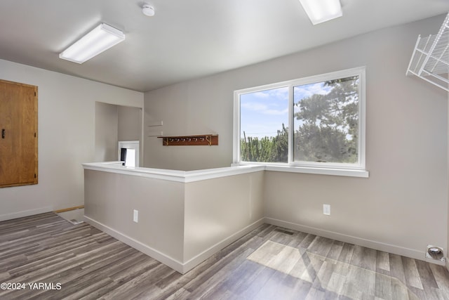 spare room featuring wood finished floors and baseboards