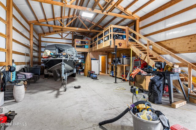 garage with freestanding refrigerator and metal wall