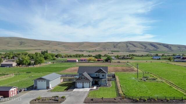 birds eye view of property featuring a mountain view and a rural view