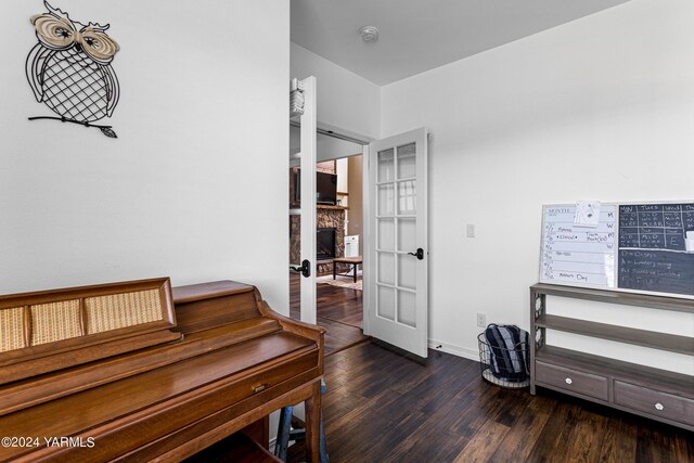 living area featuring baseboards and dark wood-type flooring