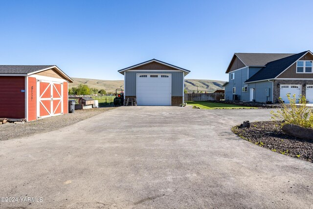 exterior space featuring a storage shed, fence, and a mountain view