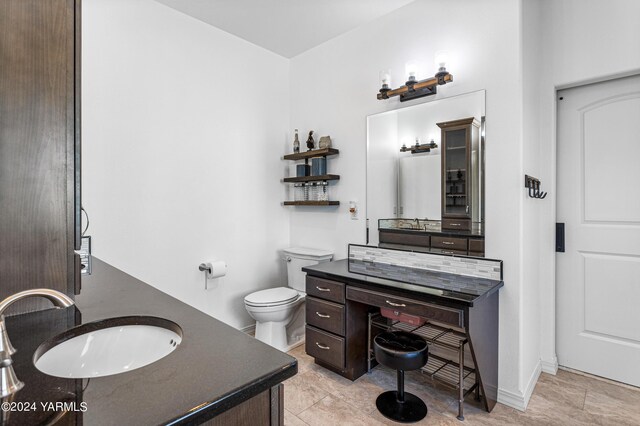 full bathroom with toilet and vanity