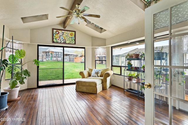 sunroom / solarium with vaulted ceiling with skylight and ceiling fan