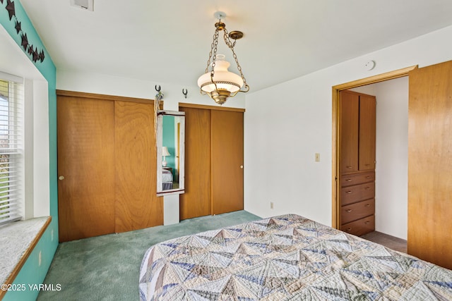 carpeted bedroom with multiple closets