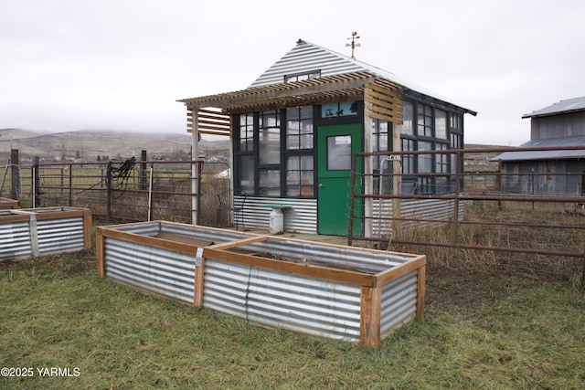 view of outbuilding with a vegetable garden