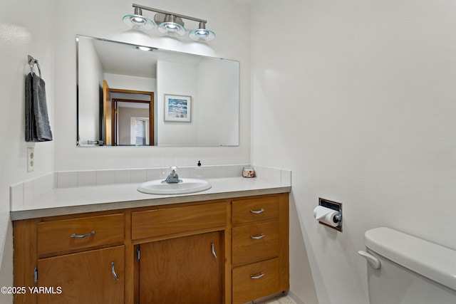 half bathroom featuring toilet and vanity