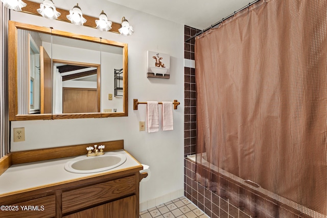 bathroom featuring vanity, shower / tub combo with curtain, and tile patterned floors