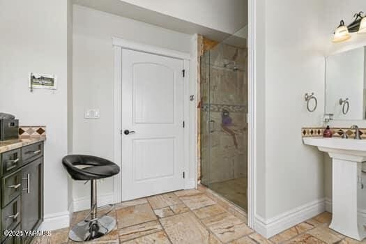 921 Tibbling Rd, Selah, WA 98942 - full bathroom featuring a stall shower, stone tile floors, and baseboards