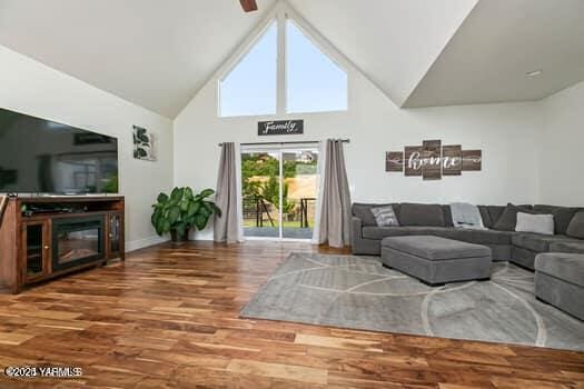 921 Tibbling Rd, Selah, WA 98942 - living area featuring wood finished floors, high vaulted ceiling, and baseboards