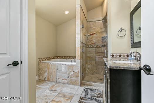 921 Tibbling Rd, Selah, WA 98942 - full bath featuring vanity, a garden tub, a shower stall, and vaulted ceiling