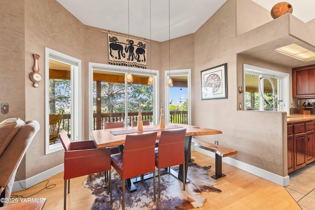 131 Katie Ln, Selah, WA 98942 - dining space with healthy amount of natural light, baseboards, a towering ceiling, and light wood-type flooring
