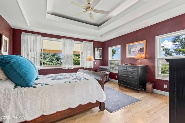 131 Katie Ln, Selah, WA 98942 - bedroom with wood finished floors, a tray ceiling, ceiling fan, and baseboards