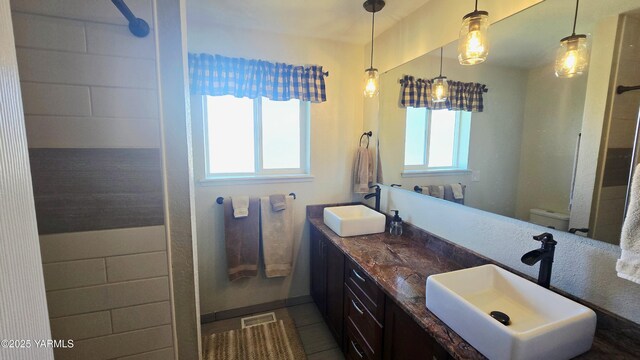 15911 Fisk Rd, Yakima, WA 98908 - full bath with double vanity, toilet, and tile patterned flooring