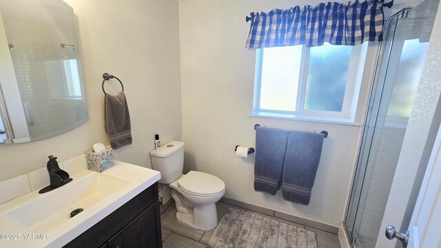 15911 Fisk Rd, Yakima, WA 98908 - bathroom featuring vanity, tiled shower, and toilet