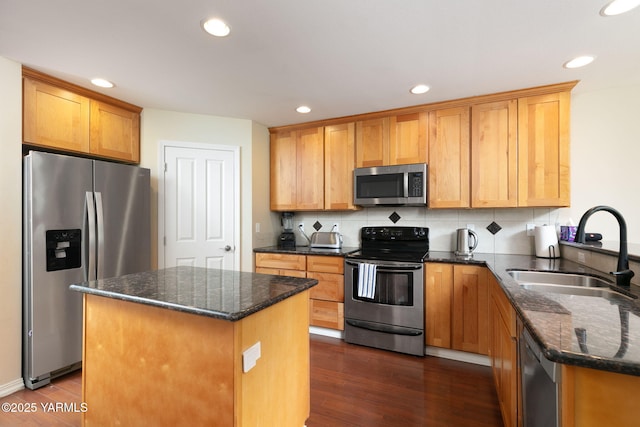 310 W Riverview Ave Unit C, Selah, WA 98942 - kitchen featuring stainless steel appliances, dark wood-type flooring, dark stone countertops, a center island, and recessed lighting
