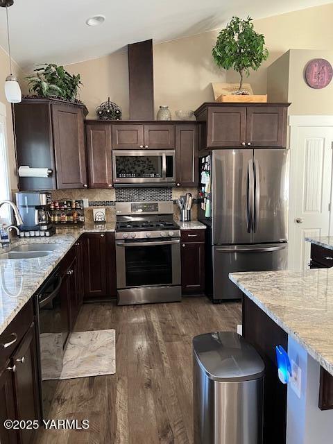 522 Adobe Way, Selah, WA 98942 - kitchen with stainless steel appliances, a sink, dark brown cabinetry, light stone countertops, and dark wood finished floors