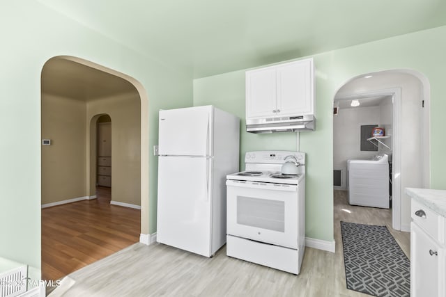 kitchen with arched walkways, washing machine and dryer, light wood-type flooring, white appliances, and under cabinet range hood