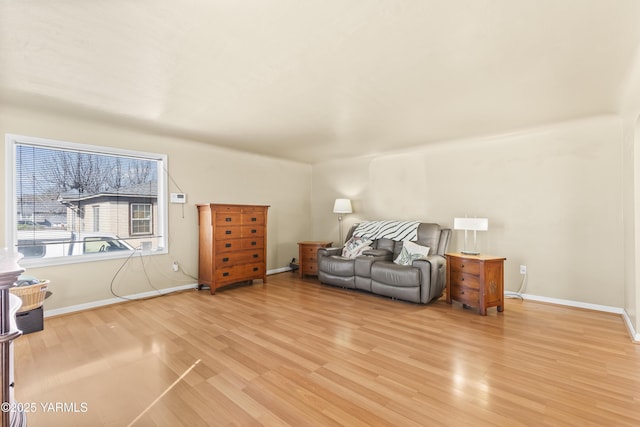 sitting room featuring baseboards and light wood finished floors