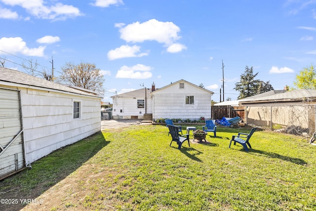view of yard featuring fence and an outdoor fire pit