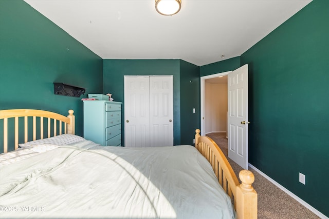 bedroom with carpet floors, a closet, and baseboards