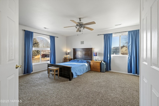 carpeted bedroom featuring ceiling fan, visible vents, and baseboards