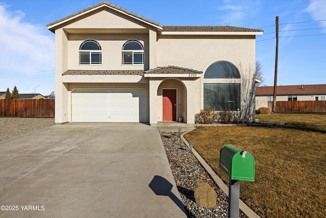 traditional-style home with a tile roof, stucco siding, concrete driveway, a front yard, and fence