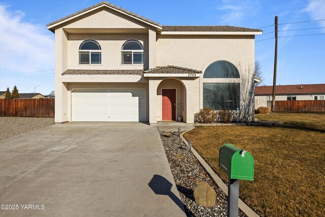 traditional-style home with a tile roof, stucco siding, concrete driveway, a front yard, and fence