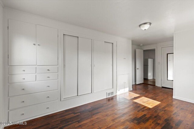 3803 Tieton Dr, Yakima, WA 98902 - unfurnished bedroom with freestanding refrigerator, dark wood finished floors, and baseboards