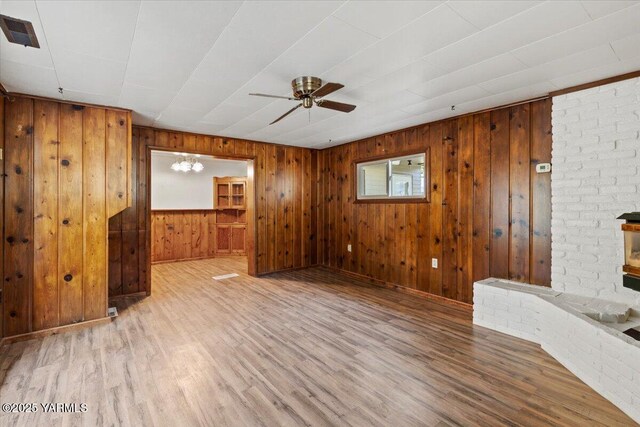 3803 Tieton Dr, Yakima, WA 98902 - unfurnished living room with a ceiling fan, wood finished floors, and wood walls