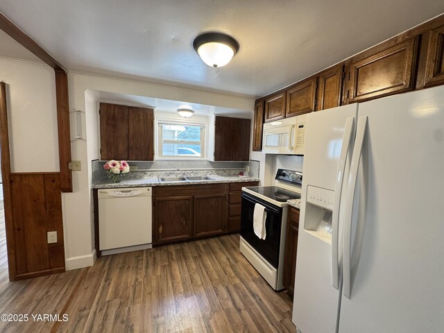 3803 Tieton Dr, Yakima, WA 98902 - kitchen with white appliances, wood finished floors, light countertops, a sink, and dark brown cabinetry