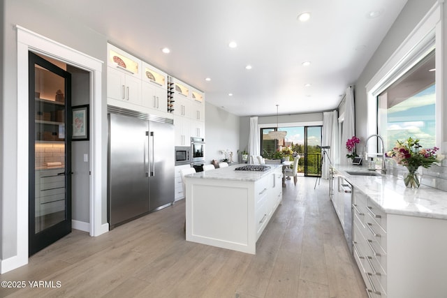 7902 Poplar View Way, Yakima, WA 98908 - kitchen featuring built in appliances, a sink, a center island, light wood finished floors, and recessed lighting