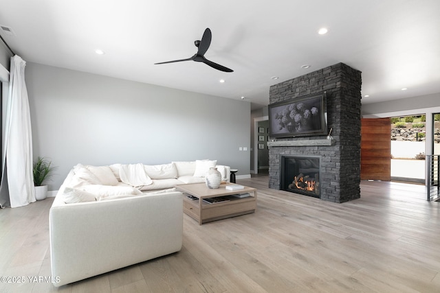 7902 Poplar View Way, Yakima, WA 98908 - living room with ceiling fan, a stone fireplace, wood finished floors, baseboards, and recessed lighting