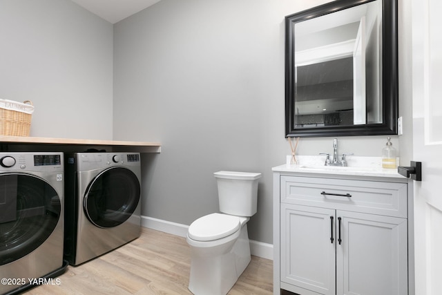 7902 Poplar View Way, Yakima, WA 98908 - washroom with washing machine and dryer, light wood-style flooring, baseboards, and wet bar