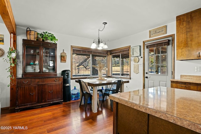 dining room with dark wood finished floors and a chandelier