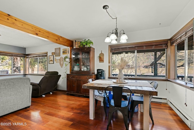 dining space with a baseboard heating unit, beamed ceiling, a notable chandelier, and wood-type flooring