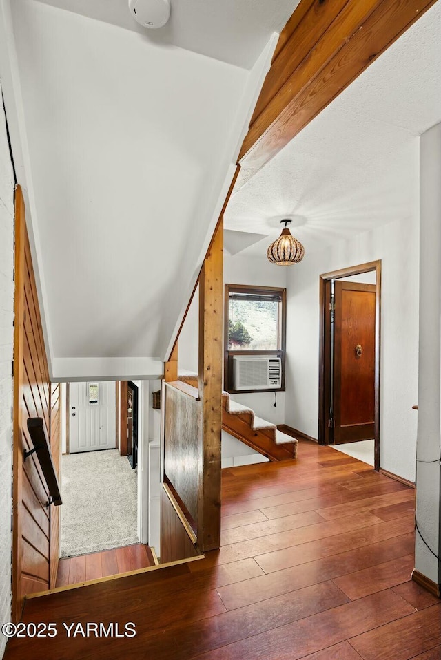 corridor with cooling unit, stairs, and hardwood / wood-style floors