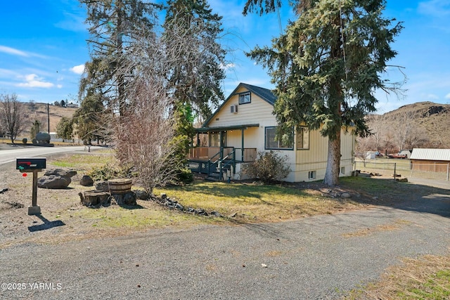 view of front facade with fence and a mountain view