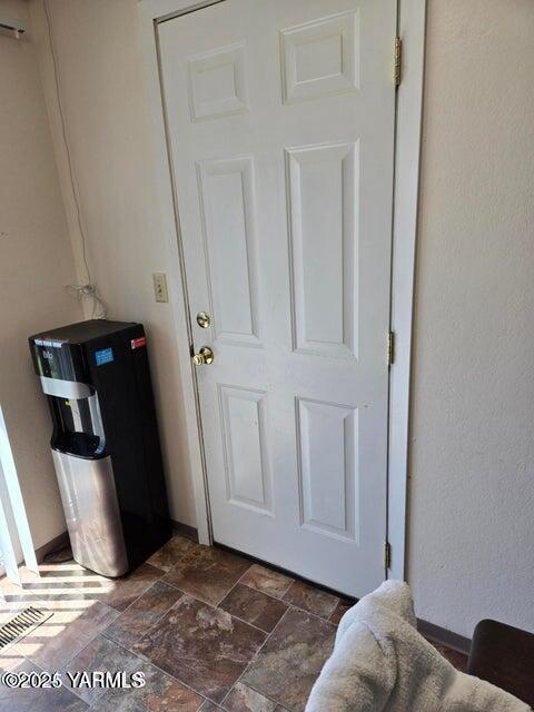 interior space with stone finish flooring and baseboards