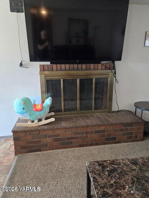 interior details with a brick fireplace