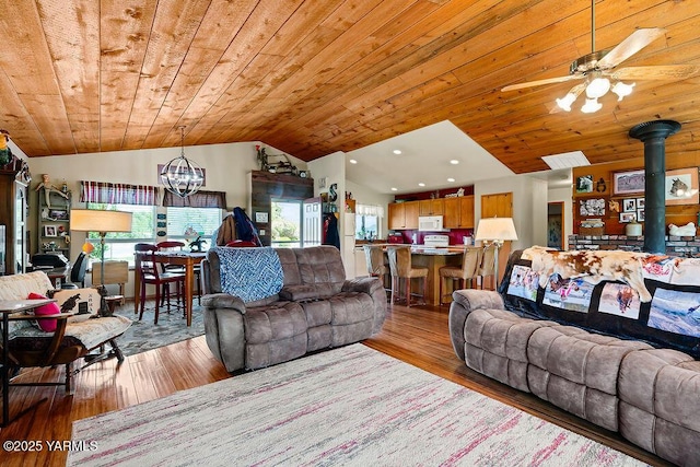 2810 S 79th Ave, Yakima, WA 98903 - living room featuring a chandelier, wood ceiling, lofted ceiling, a wood stove, and hardwood / wood-style flooring