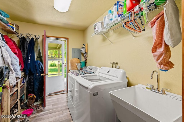2810 S 79th Ave, Yakima, WA 98903 - washroom featuring washing machine and dryer, light wood-type flooring, and electric panel