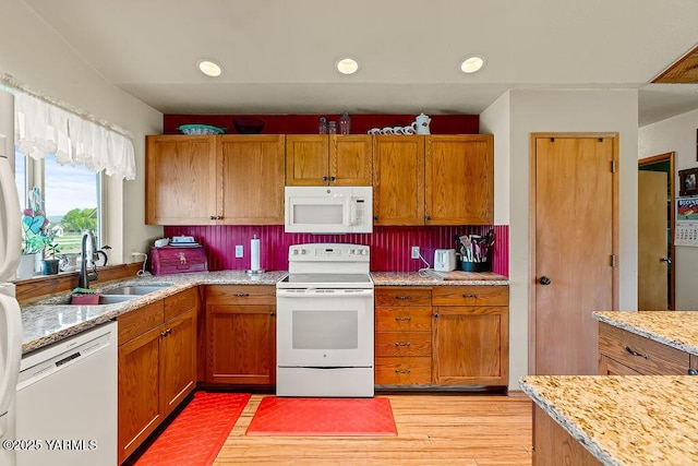 2810 S 79th Ave, Yakima, WA 98903 - kitchen with white appliances, brown cabinets, light wood-style flooring, recessed lighting, and light stone countertops