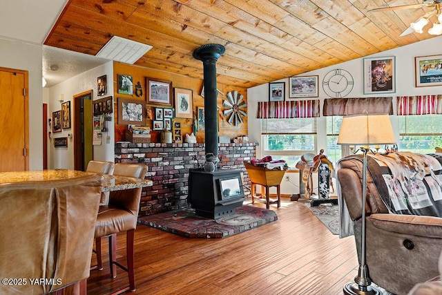 2810 S 79th Ave, Yakima, WA 98903 - living area featuring a wood stove, vaulted ceiling, wooden ceiling, hardwood / wood-style floors, and ceiling fan