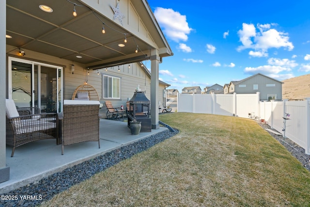 view of yard with a patio, a residential view, a fenced backyard, and an outdoor living space