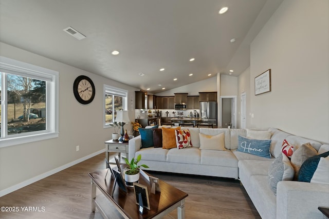 living area with recessed lighting, visible vents, baseboards, vaulted ceiling, and dark wood-style floors