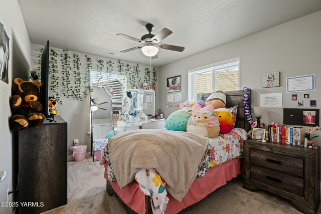 carpeted bedroom with ceiling fan and visible vents