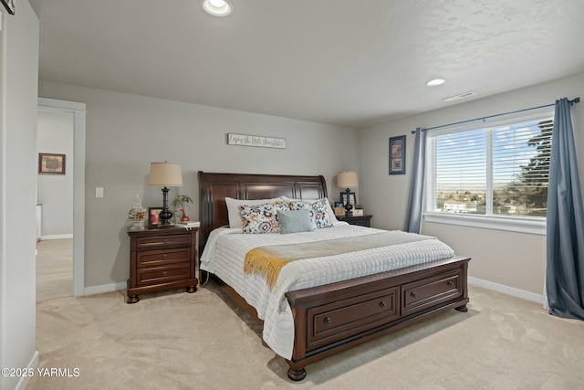 bedroom with recessed lighting, light colored carpet, visible vents, and baseboards