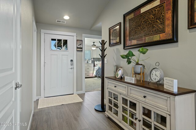 entrance foyer with visible vents, dark wood finished floors, and baseboards