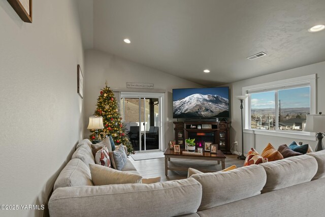 living room featuring vaulted ceiling, wood finished floors, visible vents, and recessed lighting